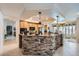 Stylish kitchen with stone breakfast bar, tile flooring, and modern appliances at 8325 Villa De Medici St, Las Vegas, NV 89131