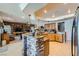 Bright kitchen featuring an island with stone accents, wooden cabinetry, and stainless steel appliances at 8325 Villa De Medici St, Las Vegas, NV 89131