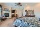 Spacious main bedroom with a fireplace, ceiling fan, and elegant furnishings at 8325 Villa De Medici St, Las Vegas, NV 89131