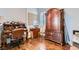 Charming home office with hardwood floors, a wooden desk, and a classic armoire at 8325 Villa De Medici St, Las Vegas, NV 89131