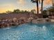 Serene backyard pool featuring a rock waterfall, surrounded by landscaping, offering a tranquil retreat at 8325 Villa De Medici St, Las Vegas, NV 89131