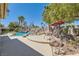 Beautiful backyard pool with rock waterfall feature and ample seating for entertaining at 8325 Villa De Medici St, Las Vegas, NV 89131