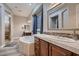 Bright bathroom with a soaking tub, step-in shower, dual sink vanity, and decorative accents at 8705 Killians Greens Dr, Las Vegas, NV 89131