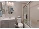 Cozy bathroom features a modern vanity, round mirror, and glass-enclosed shower at 8705 Killians Greens Dr, Las Vegas, NV 89131