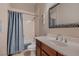 Bathroom vanity with framed mirror and combined shower and tub at 8705 Killians Greens Dr, Las Vegas, NV 89131