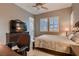 This cozy bedroom has a ceiling fan, shutters, and a view of the hallway at 8705 Killians Greens Dr, Las Vegas, NV 89131