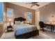 Comfortable bedroom features a ceiling fan, shuttered windows, and a desk at 8705 Killians Greens Dr, Las Vegas, NV 89131