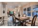 Elegant dining room featuring a chandelier, large windows, and view to living room, ideal for gatherings at 8705 Killians Greens Dr, Las Vegas, NV 89131