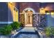 Inviting front entrance with stone accents, decorative lighting, and a charming walkway at 8705 Killians Greens Dr, Las Vegas, NV 89131