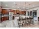 Modern kitchen features stainless appliances, a large island with seating and pendant lighting, and ample cabinet space at 8705 Killians Greens Dr, Las Vegas, NV 89131