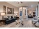 Spacious living room with modern decor and an open floor plan leading to the dining area at 8705 Killians Greens Dr, Las Vegas, NV 89131