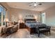 Comfortable primary bedroom boasting a cozy sitting area, elegant decor, and ample natural light at 8705 Killians Greens Dr, Las Vegas, NV 89131