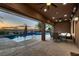 Relaxing covered patio with outdoor dining area and view of the pool, perfect for entertaining at 8705 Killians Greens Dr, Las Vegas, NV 89131