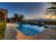 Backyard oasis featuring a sparkling pool, jacuzzi, and lush landscaping at 8705 Killians Greens Dr, Las Vegas, NV 89131