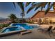 Stunning outdoor area with a pool, spa, and covered patio for relaxing and entertaining at 8705 Killians Greens Dr, Las Vegas, NV 89131