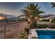 Backyard featuring a sparkling pool, lush landscaping, and a serene mountain view at 8705 Killians Greens Dr, Las Vegas, NV 89131