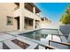 Backyard showcasing a sparkling pool, outdoor dining, fire pit, and landscape at 881 Cherry Glen Pl, Las Vegas, NV 89138