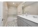 Modern bathroom with double sinks, gray vanity, and a shower-tub with glass doors at 881 Cherry Glen Pl, Las Vegas, NV 89138