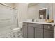 Stylish bathroom with a glass-enclosed shower, gray vanity, and patterned tile floor at 881 Cherry Glen Pl, Las Vegas, NV 89138