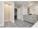 A modern bathroom features a double vanity and stylish tile flooring, creating an elegant and functional space at 881 Cherry Glen Pl, Las Vegas, NV 89138