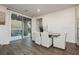 Elegant dining area with a modern table, six chairs, and a large sliding glass door at 881 Cherry Glen Pl, Las Vegas, NV 89138