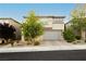 Charming two-story home with manicured front yard, paver driveway, and a spacious two car garage at 881 Cherry Glen Pl, Las Vegas, NV 89138