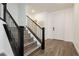 Bright foyer features wood floors, modern metal and wood staircase and a white entry door at 881 Cherry Glen Pl, Las Vegas, NV 89138
