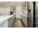 Modern kitchen with stainless steel appliances, white countertops, and gray cabinetry at 881 Cherry Glen Pl, Las Vegas, NV 89138