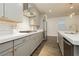 Modern kitchen featuring sleek gray cabinetry, subway tile backsplash, and stainless steel appliances at 881 Cherry Glen Pl, Las Vegas, NV 89138