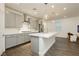 Bright, modern kitchen with gray cabinets, stainless steel appliances, and a large island with quartz countertop at 881 Cherry Glen Pl, Las Vegas, NV 89138