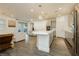Open-concept living area with gray cabinets and stainless steel appliances at 881 Cherry Glen Pl, Las Vegas, NV 89138