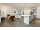 Open-concept living room with hardwood floors, lots of natural light, and seamless access to the kitchen and outdoor area at 881 Cherry Glen Pl, Las Vegas, NV 89138