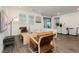 Bright living room with neutral decor, wood-look floors, modern furniture, and access to a patio at 881 Cherry Glen Pl, Las Vegas, NV 89138
