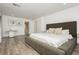Spacious primary bedroom featuring a king-size bed, wood floors, and ensuite bathroom at 881 Cherry Glen Pl, Las Vegas, NV 89138