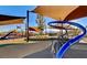 Modern playground with slides and shade structures for outdoor fun at 881 Cherry Glen Pl, Las Vegas, NV 89138