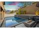 Inviting pool area with a modern fire pit and elegant landscaping, perfect for outdoor relaxation and entertaining at 881 Cherry Glen Pl, Las Vegas, NV 89138