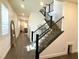 Modern staircase with wood steps, and iron railings leading to a bright, open landing at 881 Cherry Glen Pl, Las Vegas, NV 89138