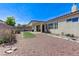 Expansive backyard offers a cozy patio, green turf, desert landscaping, and plenty of room to enjoy the outdoors at 9243 White Waterfall Ave, Las Vegas, NV 89149