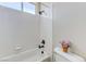 Bathroom featuring white tiled shower, and toilet with decorations at 9243 White Waterfall Ave, Las Vegas, NV 89149