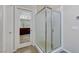Modern bathroom showcasing a glass-enclosed shower stall and a view of the vanity through the doorway at 9243 White Waterfall Ave, Las Vegas, NV 89149