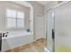 Modern bathroom with soaking tub and glass-enclosed shower at 9243 White Waterfall Ave, Las Vegas, NV 89149