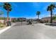View of community gate featuring desert landscaping and palm trees at 9243 White Waterfall Ave, Las Vegas, NV 89149