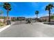 Elegant community gate featuring towering palm trees and beautifully landscaped entrance at 9243 White Waterfall Ave, Las Vegas, NV 89149