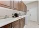 Laundry room with upper cabinets, sink, countertop and washer and dryer at 9243 White Waterfall Ave, Las Vegas, NV 89149