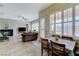 Bright living room and dining nook feature many windows and tile flooring at 9243 White Waterfall Ave, Las Vegas, NV 89149