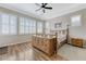 The main bedroom features wood floors, a ceiling fan, and three windows at 9243 White Waterfall Ave, Las Vegas, NV 89149