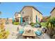 Inviting backyard with patio furniture, umbrellas, well-manicured plants, and a touch of decorative charm at 9412 Jewel Lake Ave, Las Vegas, NV 89166