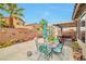 Cozy backyard with desert landscaping, palm tree, patio, and outdoor decor at 9412 Jewel Lake Ave, Las Vegas, NV 89166