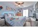 Relaxing bedroom featuring neutral carpet, ceiling fan, and an accent wall painted in shades of light blue at 9412 Jewel Lake Ave, Las Vegas, NV 89166