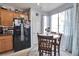 Charming breakfast nook with a round table, black fridge, and soft natural light at 9412 Jewel Lake Ave, Las Vegas, NV 89166